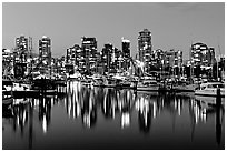 Fishing boats and skyline light reflected at night. Vancouver, British Columbia, Canada ( black and white)