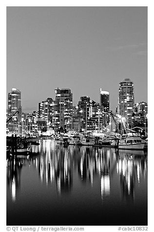 Fishing boats and skyline light reflected at night. Vancouver, British Columbia, Canada (black and white)