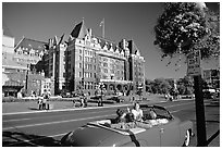 Red convertible car and Empress hotel. Victoria, British Columbia, Canada (black and white)