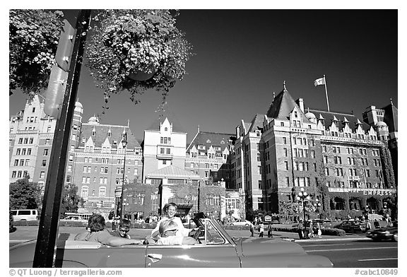 Red convertible car and Empress hotel. Victoria, British Columbia, Canada (black and white)