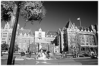 Red convertible car and Empress hotel. Victoria, British Columbia, Canada ( black and white)