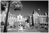 Red convertible car and Empress hotel. Victoria, British Columbia, Canada (black and white)