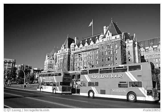 Red double-decker tour busses in front of Empress hotel. Victoria, British Columbia, Canada (black and white)
