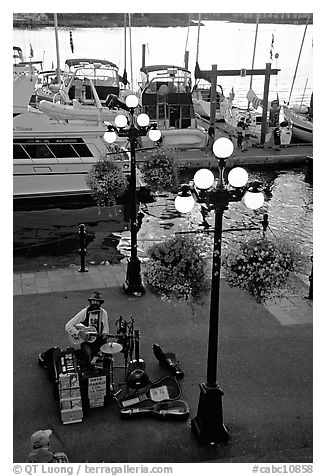 Street performers on the quay of Inner Harbor. Victoria, British Columbia, Canada (black and white)
