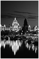 Parliament buildings lights reflected in the harbor. Victoria, British Columbia, Canada (black and white)