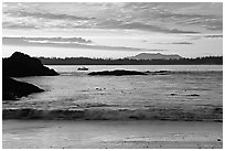 Marine landscape with a small boat in a distance, sunset. Pacific Rim National Park, Vancouver Island, British Columbia, Canada ( black and white)