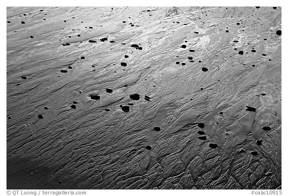 Pebbles and wet sand at sunset, Half-moon bay. Pacific Rim National Park, Vancouver Island, British Columbia, Canada