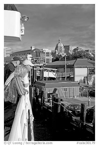 Passengers standing on the deck of the ferry, as it sails into the Inner Harbor. Victoria, British Columbia, Canada