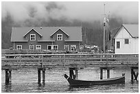 Pier and waterfront buildings, Tofino. Vancouver Island, British Columbia, Canada (black and white)