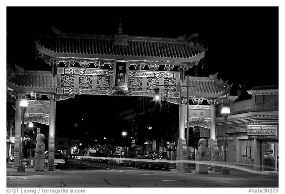 Gate of Harmonious Interest marking the entrance of Chinatown, night. Victoria, British Columbia, Canada (black and white)