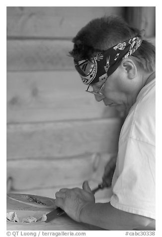 Artist carving a totem pole. Butchart Gardens, Victoria, British Columbia, Canada (black and white)