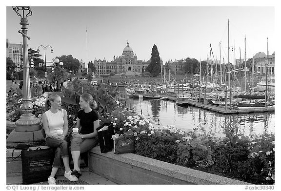 Young Women sitting, Inner harbor. Victoria, British Columbia, Canada