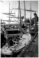 Kids in a small sailboat docked in Inner Habor. Victoria, British Columbia, Canada ( black and white)