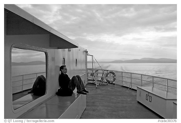 Passenger sitting on the deck of ferry. Vancouver Island, British Columbia, Canada (black and white)