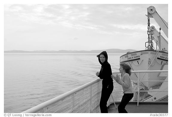 Woman and girl looking out from deck of ferry. Vancouver Island, British Columbia, Canada (black and white)