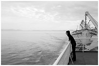 Woman looking out from deck of ferry. Vancouver Island, British Columbia, Canada (black and white)