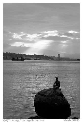 Girl in wetsuit statue, sunrise, Stanley Park. Vancouver, British Columbia, Canada