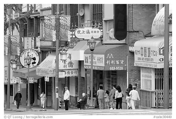 Street in Chinatown with red lamp posts and Chinese characters. Vancouver, British Columbia, Canada