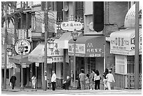 Street in Chinatown with red lamp posts and Chinese characters. Vancouver, British Columbia, Canada (black and white)