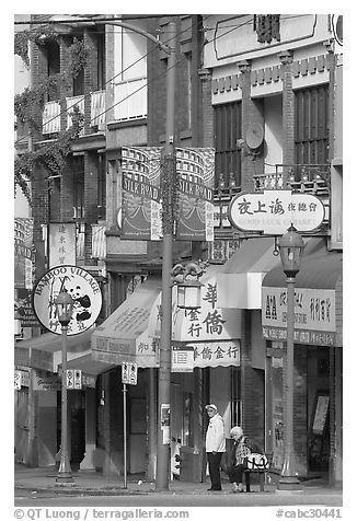 Street in Chinatown with red lamp posts and Chinese script. Vancouver, British Columbia, Canada (black and white)