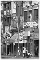 Street in Chinatown with red lamp posts and Chinese script. Vancouver, British Columbia, Canada (black and white)