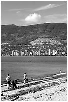 Family near the water on a beach, Stanley Park. Vancouver, British Columbia, Canada (black and white)