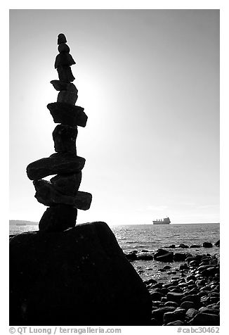 Backlit balanced rocks and ship in the distance. Vancouver, British Columbia, Canada (black and white)