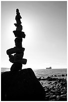 Backlit balanced rocks and ship in the distance. Vancouver, British Columbia, Canada (black and white)