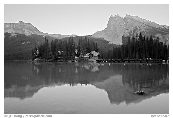 Cabins on the shore of Emerald Lake, with reflected mountains, sunset. Yoho National Park, Canadian Rockies, British Columbia, Canada (black and white)