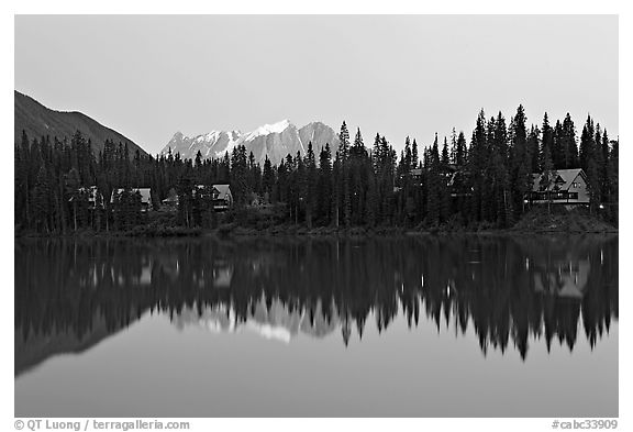 Trees and cabins reflected in Emerald Lake, dusk. Yoho National Park, Canadian Rockies, British Columbia, Canada (black and white)