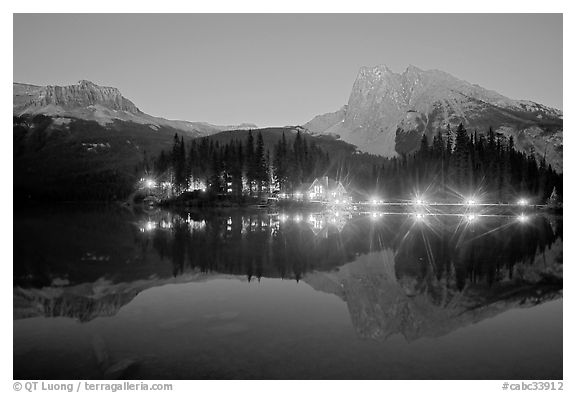 Lighted cabins and mountains reflected in Emerald Lake at night. Yoho National Park, Canadian Rockies, British Columbia, Canada (black and white)