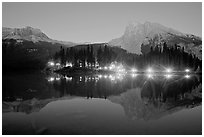 Lighted cabins and mountains reflected in Emerald Lake at night. Yoho National Park, Canadian Rockies, British Columbia, Canada ( black and white)