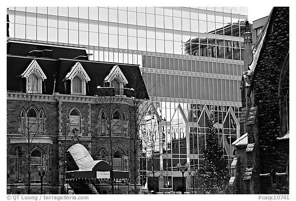 Reflection of an older building in the glass of a modern building, Montreal. Quebec, Canada (black and white)