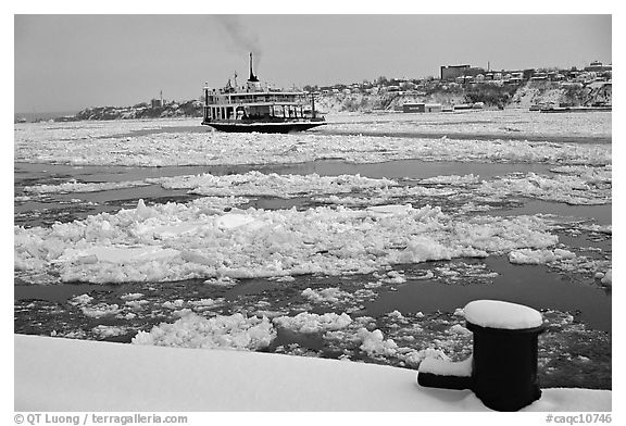 Ferry crossing the Saint Laurent river partly covered with ice, Quebec City. Quebec, Canada