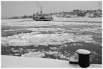 Ferry crossing the Saint Laurent river partly covered with ice, Quebec City. Quebec, Canada ( black and white)