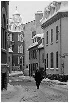 Man walking in a street in winter, Quebec City. Quebec, Canada (black and white)