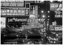 Nathan road, brilliantly lit by neon lights at night, Kowloon. Hong-Kong, China (black and white)