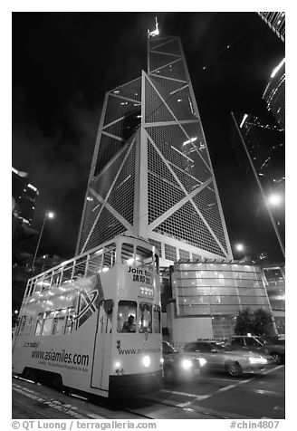 Old tram and Bank of China building (369m), designed by Pei, by night. Hong-Kong, China (black and white)