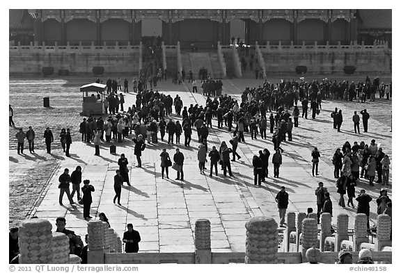 Crowd of tourists in the Sea of Flagstone (court of the imperial palace), Forbidden City. Beijing, China (black and white)