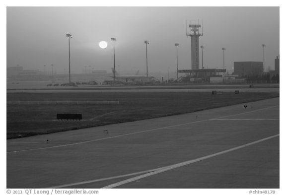 Tarmac and control tower at sunset, Beijing Capital International Airport. Beijing, China (black and white)