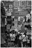 Crowded alley with clothing vendors, Kowloon. Hong-Kong, China (black and white)