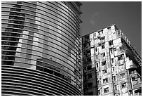 Glass building aside an old building, Kowloon. Hong-Kong, China (black and white)