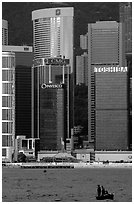 Small boat with a backdrop of skycrapers of Hong-Kong Island. Hong-Kong, China ( black and white)