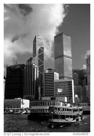 Ferry leaves a pier on Hong-Kong Island. Its symmetrical shape alleviates the need for turning around. Hong-Kong, China