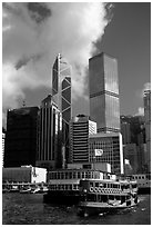 Ferry leaves a pier on Hong-Kong Island. Its symmetrical shape alleviates the need for turning around. Hong-Kong, China ( black and white)