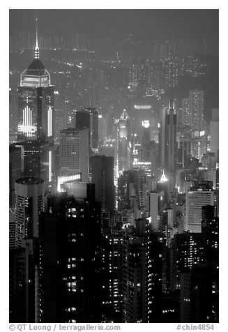 Center building with changing lights from Victoria Peak at night. Hong-Kong, China (black and white)