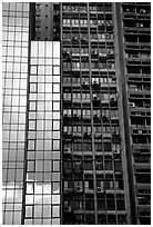 Modern building next to old  building with air conditioners, Hong-Kong Island. Hong-Kong, China (black and white)