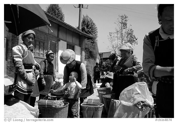 Women of Bai hill tribe offering incense for sale. Shaping, Yunnan, China (black and white)