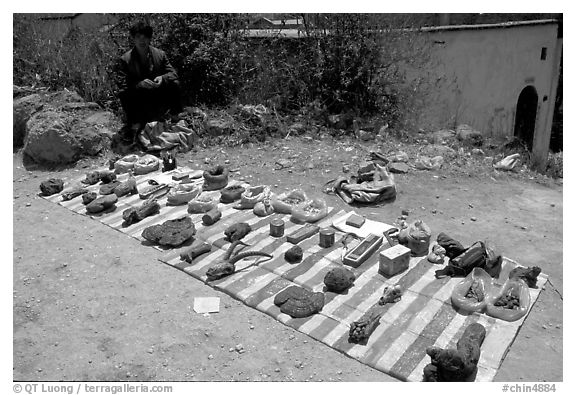 Selling strange items. Shaping, Yunnan, China (black and white)