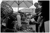 Bai tribeswomen buy vegetables at Monday market. Shaping, Yunnan, China (black and white)